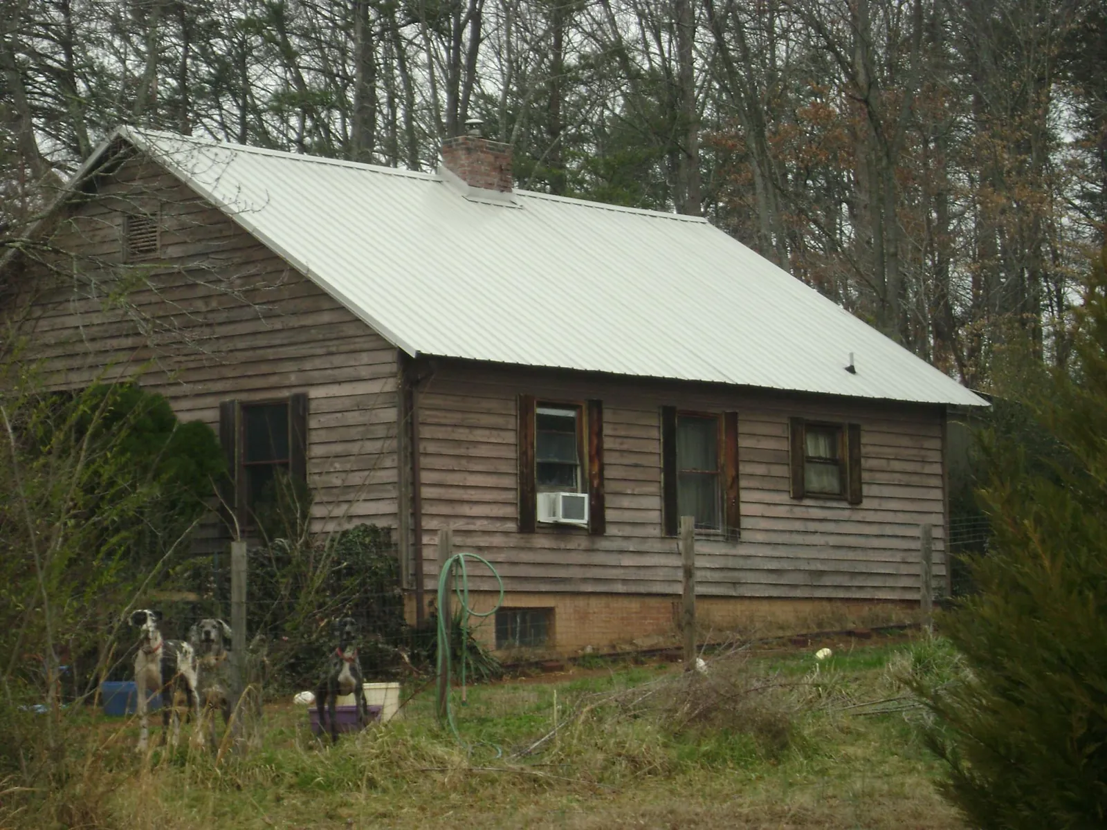 White metal roof on an old wood sided farmhouse, from a Metal Roof Installation job in Haverhill